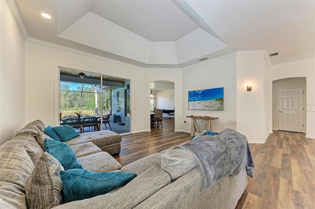 living room featuring crown molding, hardwood / wood-style floors, and a textured ceiling