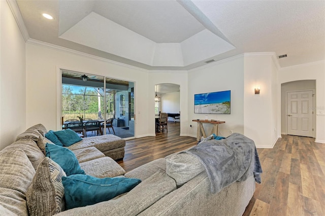 21709 Deer Pointe Xing, Bradenton, FL 34202 - living area with arched walkways, wood finished floors, a raised ceiling, ornamental molding, and recessed lighting