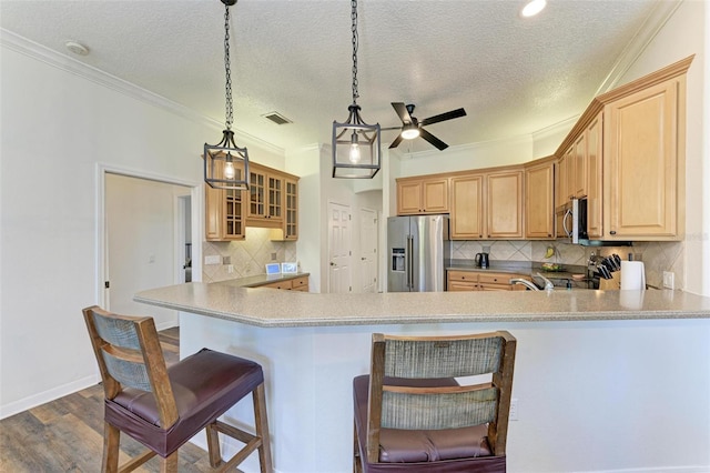 21709 Deer Pointe Xing, Bradenton, FL 34202 - kitchen featuring stainless steel appliances, ceiling fan, a textured ceiling, ornamental molding, and decorative backsplash