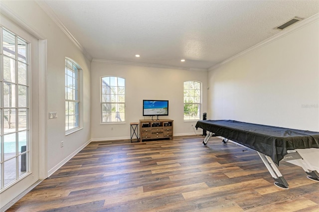 playroom featuring a textured ceiling, dark hardwood / wood-style floors, a healthy amount of sunlight, and billiards