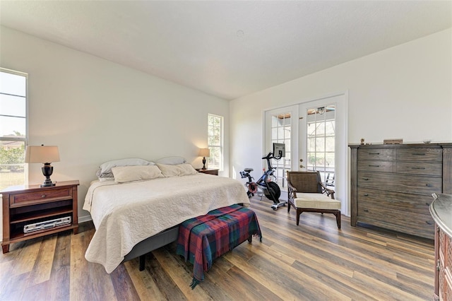 bedroom with french doors and hardwood / wood-style flooring