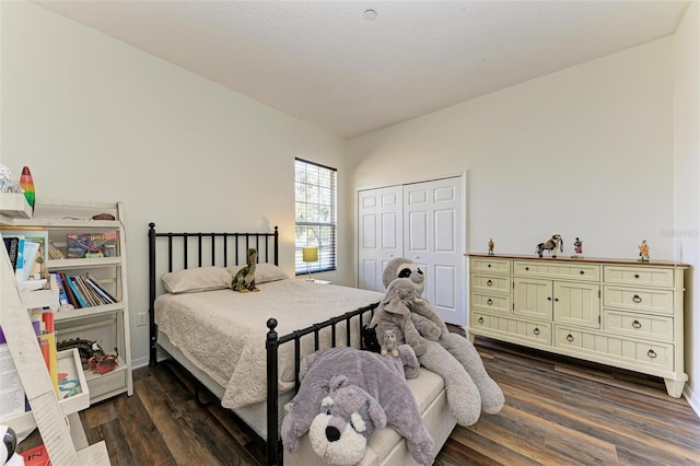 bedroom with dark wood-type flooring and a closet