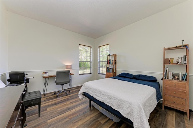 bedroom with dark hardwood / wood-style flooring