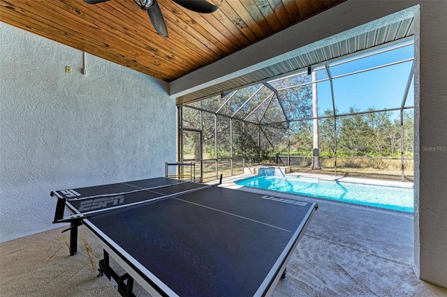 view of patio featuring ceiling fan and a lanai