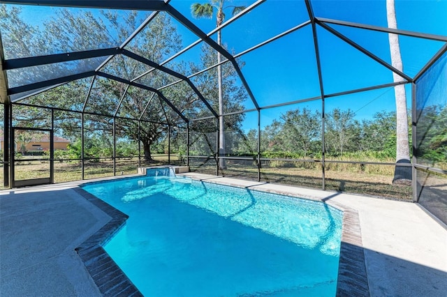 view of pool featuring glass enclosure