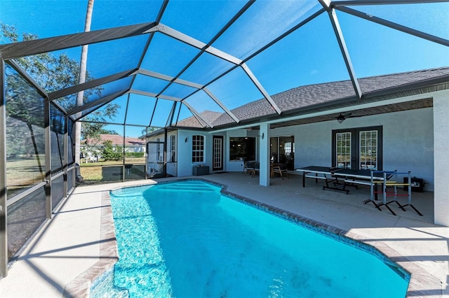 view of pool with ceiling fan, a lanai, and a patio