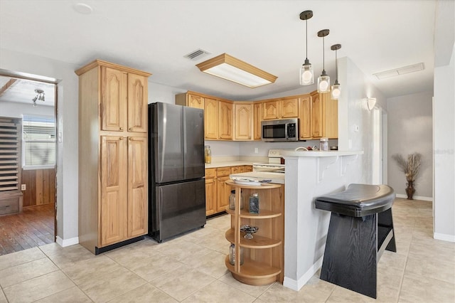 kitchen with pendant lighting, light brown cabinets, light hardwood / wood-style flooring, appliances with stainless steel finishes, and kitchen peninsula