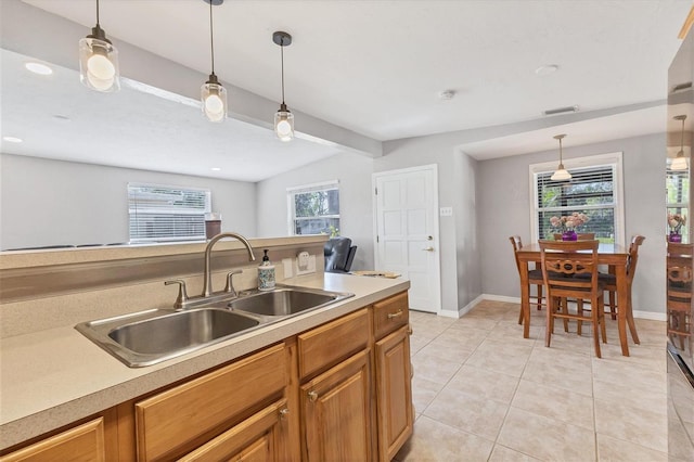 kitchen featuring a wealth of natural light, sink, and pendant lighting