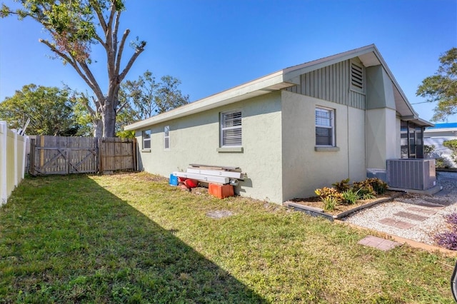 exterior space with a lawn and cooling unit