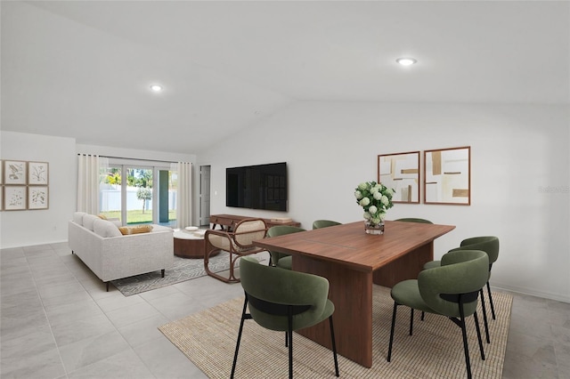 dining area featuring light tile patterned flooring and vaulted ceiling