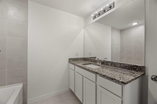 bathroom with vanity, tile patterned floors, and a bathing tub