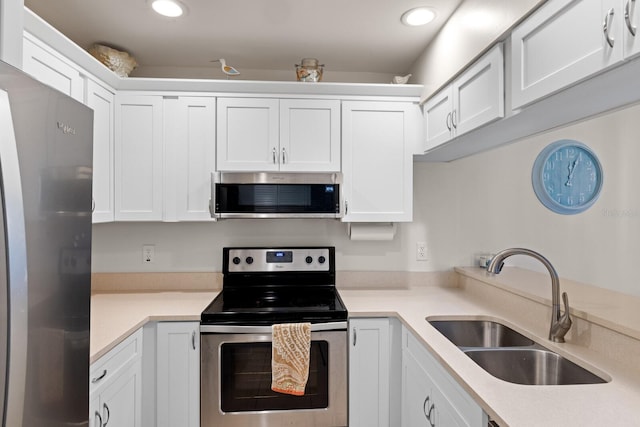 kitchen featuring white cabinetry, sink, and appliances with stainless steel finishes