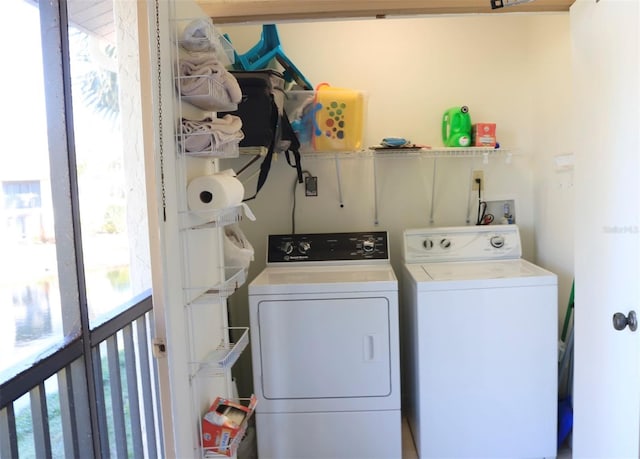 clothes washing area with washer and clothes dryer