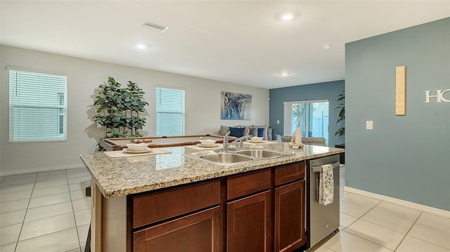 kitchen with dishwasher, plenty of natural light, a kitchen island with sink, and sink