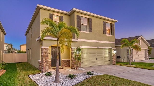 view of front of home with a yard and a garage