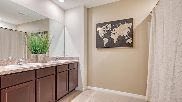 bathroom featuring tile patterned flooring and vanity