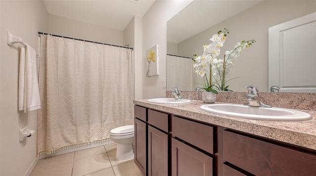 bathroom featuring tile patterned floors, vanity, and toilet