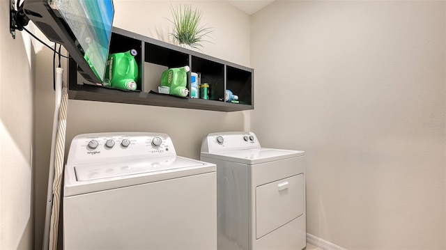 clothes washing area with washing machine and clothes dryer