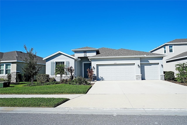 prairie-style house with a front yard and a garage