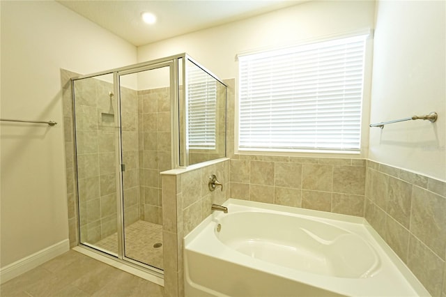 bathroom featuring tile patterned floors and shower with separate bathtub