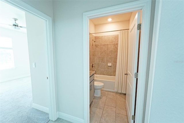 full bathroom with vanity, ceiling fan, shower / bath combo with shower curtain, tile patterned flooring, and toilet