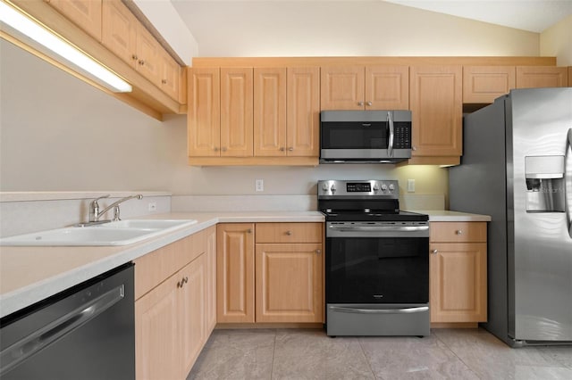 kitchen with sink, vaulted ceiling, light tile patterned floors, light brown cabinetry, and stainless steel appliances