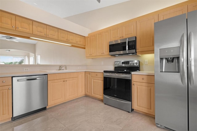 kitchen with light brown cabinets, stainless steel appliances, and sink