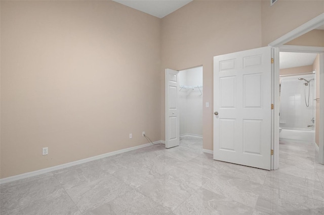 unfurnished bedroom with a spacious closet and a closet