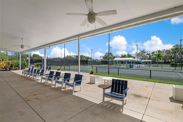 view of patio with ceiling fan and tennis court