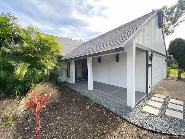 view of side of home featuring a garage