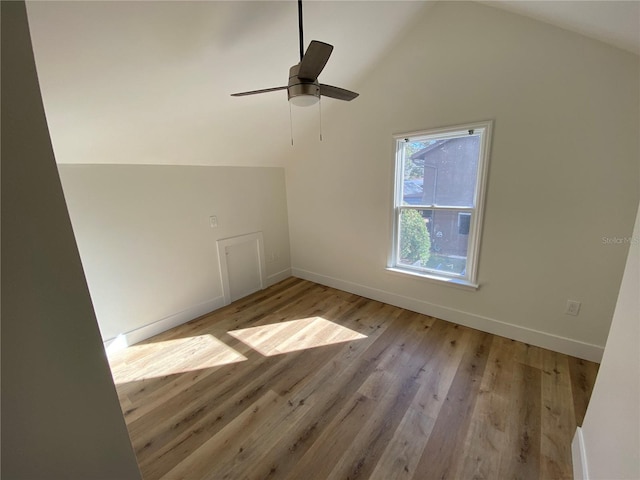 additional living space with ceiling fan, light hardwood / wood-style floors, and vaulted ceiling