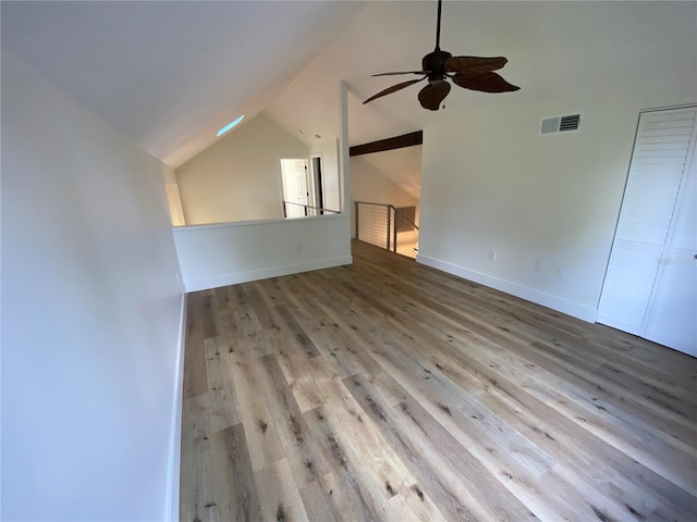 unfurnished living room with ceiling fan, lofted ceiling, and light hardwood / wood-style flooring