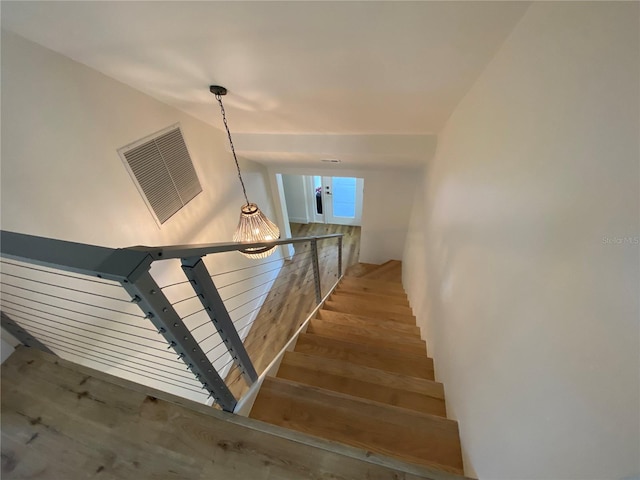 staircase with hardwood / wood-style floors