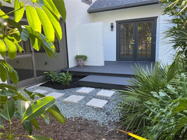 doorway to property featuring a wooden deck and french doors