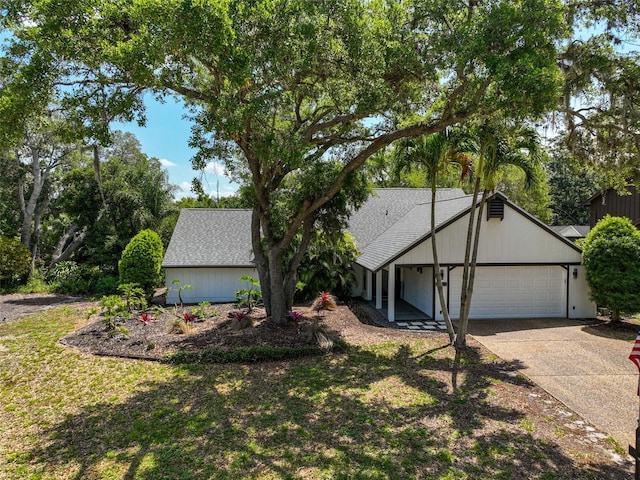 view of front of property featuring a garage and a front lawn