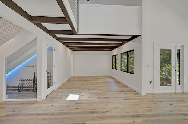 hallway featuring light hardwood / wood-style flooring and beamed ceiling