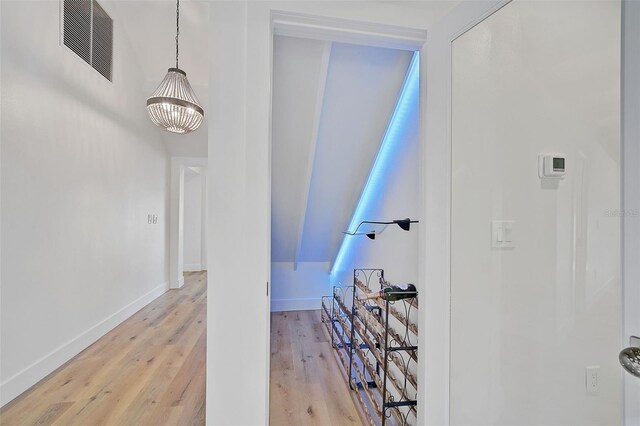 interior space with wood-type flooring and a chandelier