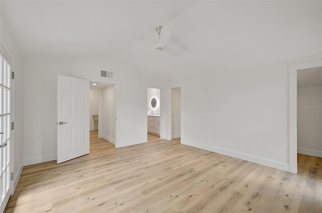 unfurnished bedroom featuring vaulted ceiling, light hardwood / wood-style floors, ceiling fan, and ensuite bathroom