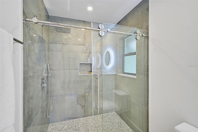 bathroom with toilet and walk in shower