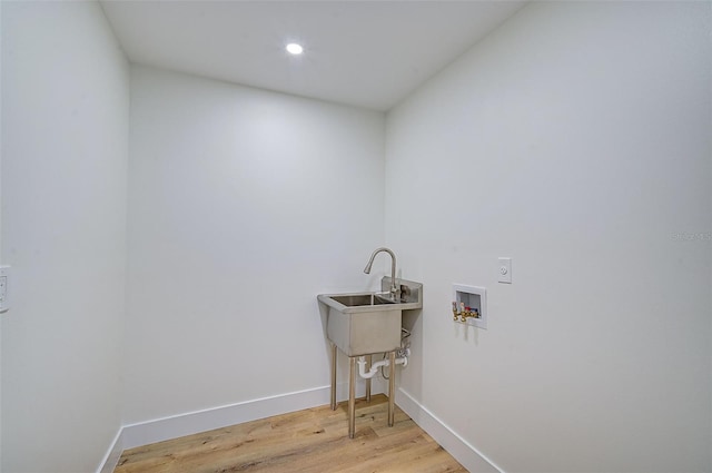 clothes washing area featuring washer hookup and light wood-type flooring