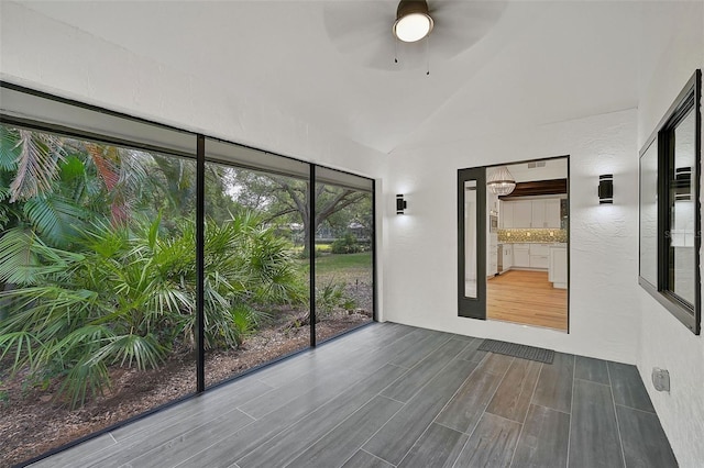 empty room with ceiling fan and lofted ceiling