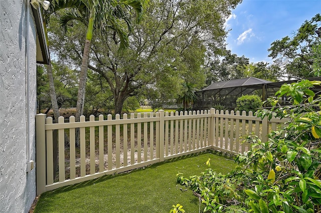 view of yard featuring glass enclosure