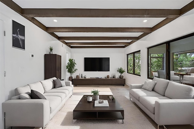 living room with plenty of natural light, light wood-type flooring, and beam ceiling