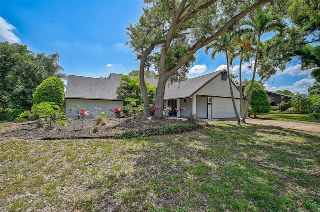 view of front facade with a garage and a front lawn