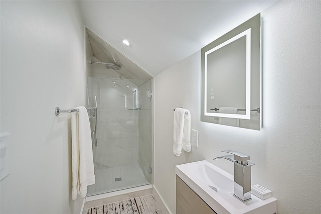 bathroom featuring vanity and an enclosed shower