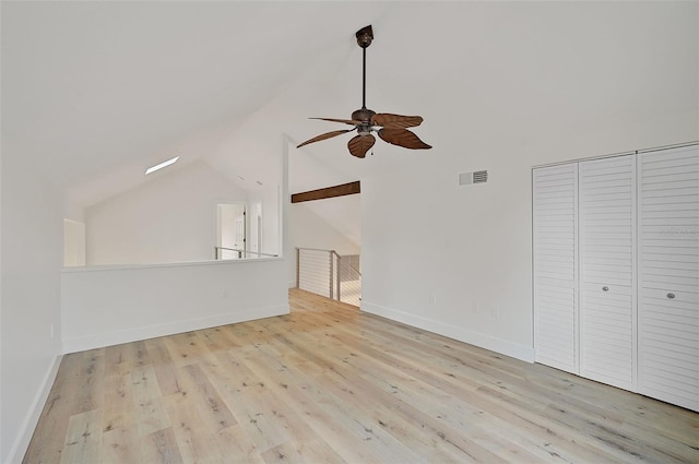 unfurnished living room with ceiling fan, vaulted ceiling, and light wood-type flooring