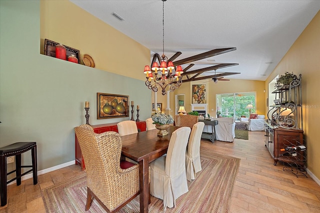 dining space featuring ceiling fan with notable chandelier, light wood-type flooring, lofted ceiling, and a textured ceiling