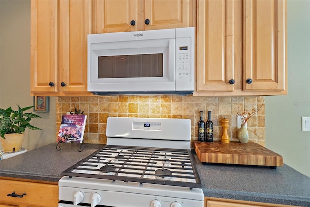 kitchen featuring white appliances and backsplash