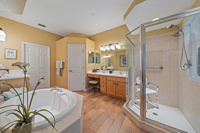 bathroom with vanity and independent shower and bath