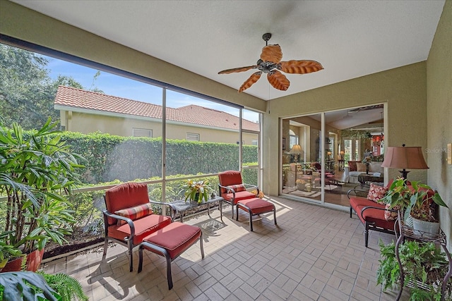 sunroom / solarium featuring ceiling fan